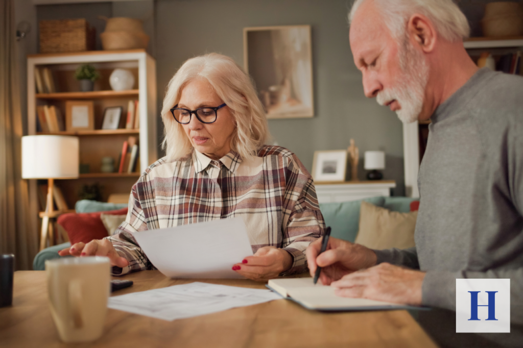 A financial advisor reviews retirement risks with a client, focusing on the potential impact of tax rate increases on long-term retirement planning.